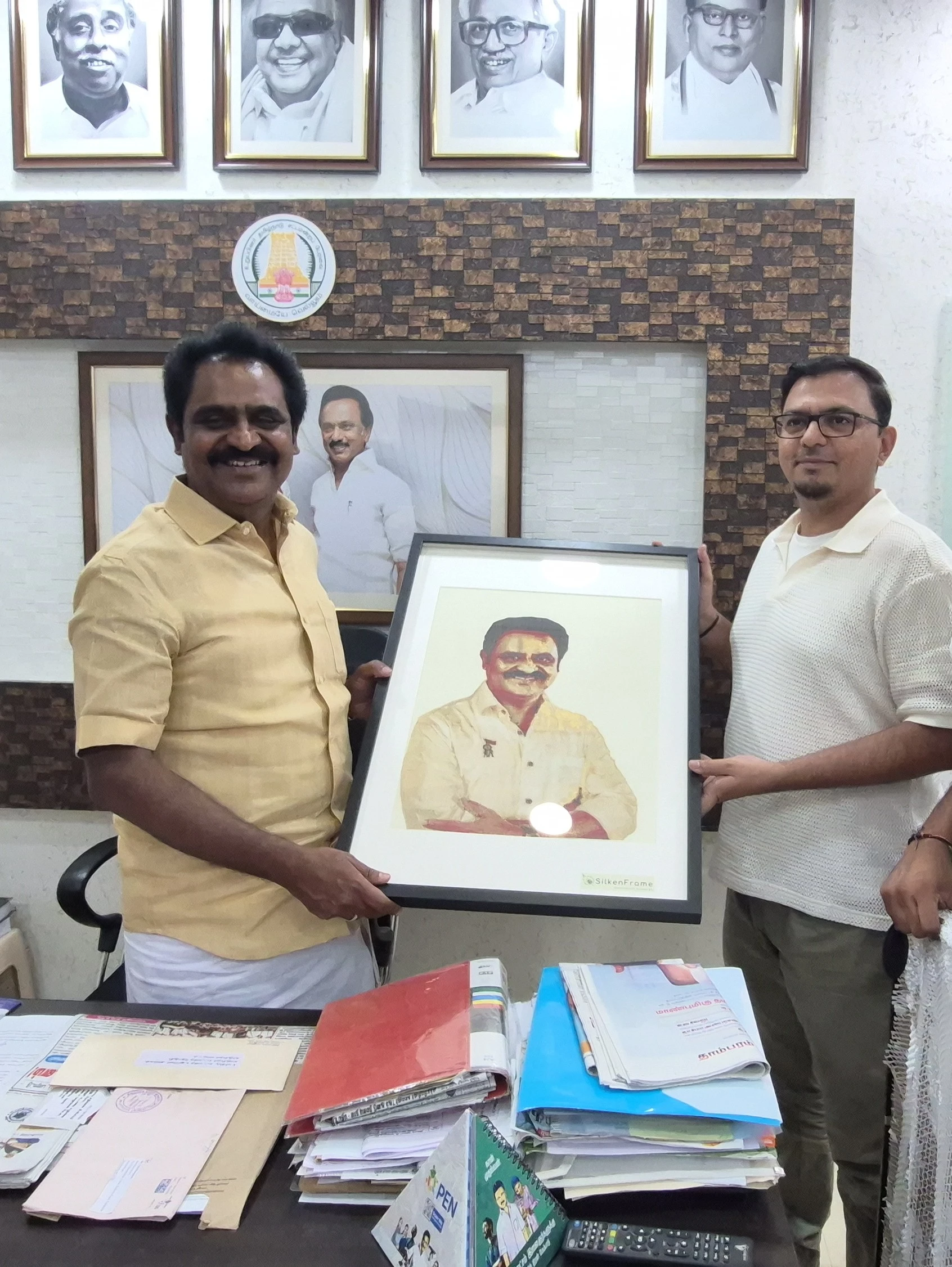 Hon. MLA C. V. M. P. Ezhilarasan receiving a handcrafted pure Kanjivaram silk portrait of himself from SilkenFrame.